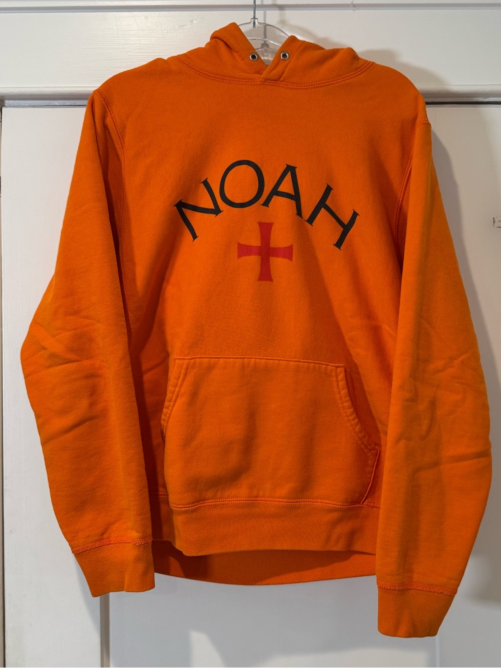 Noah NYC Orange Hoodie with Black Logo and Red Cross